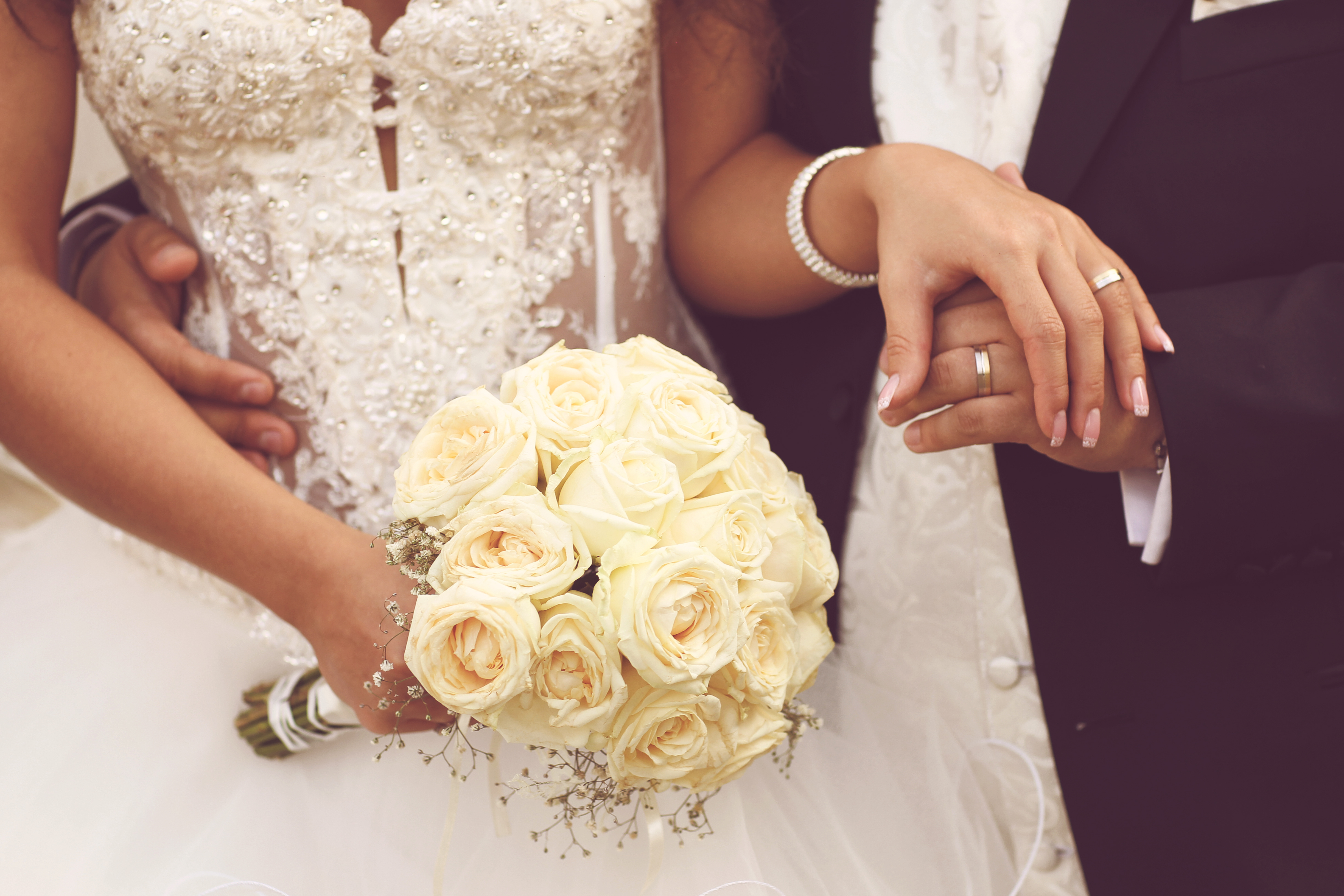 Close Up of Formal Bride and Groom Hold Hands
