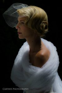 Dramatic photo of bride wrapped in tulle and wearing a netted veil