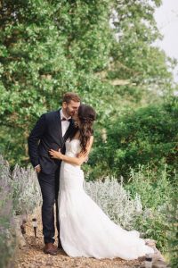 Bride and Groom kiss among the trees