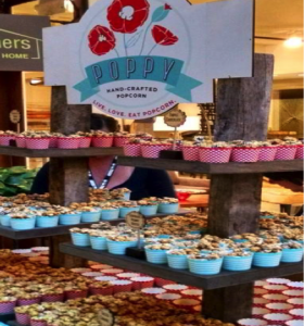 Tiers of shelves serve Poppy Handcrafted Popcorn.